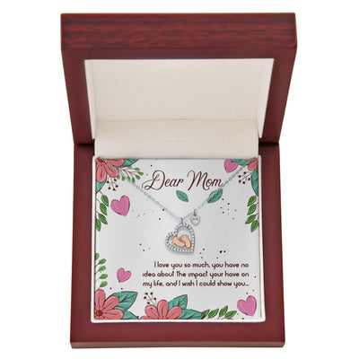 “Heart‑shaped silver and rose gold necklace in a gift box with a floral card reading ‘Dear Mom, I love you so much.