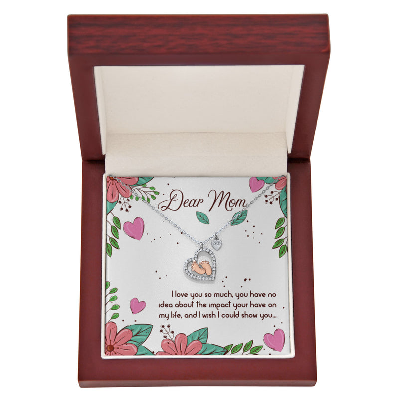 “Heart‑shaped silver and rose gold necklace in a gift box with a floral card reading ‘Dear Mom, I love you so much.
