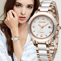 Woman wearing a silver and rose gold watch with a close-up of the watch face.